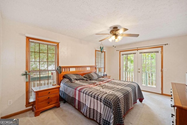 carpeted bedroom featuring access to outside, a textured ceiling, ceiling fan, and french doors