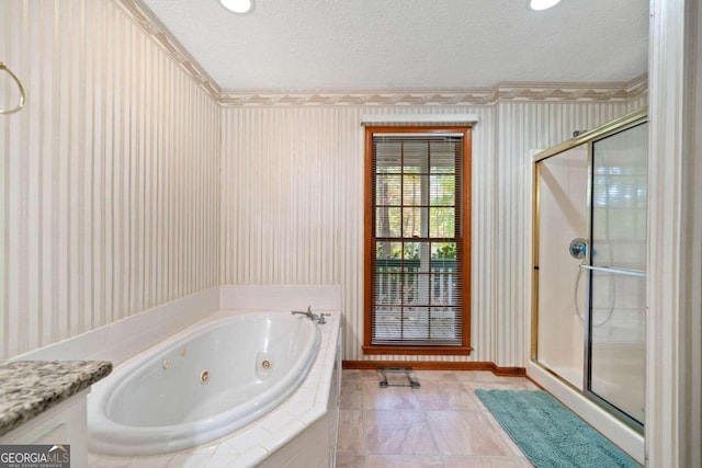 bathroom featuring vanity, a textured ceiling, and independent shower and bath