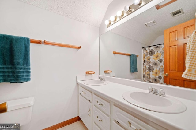 bathroom featuring vanity, a shower with shower curtain, a textured ceiling, and vaulted ceiling