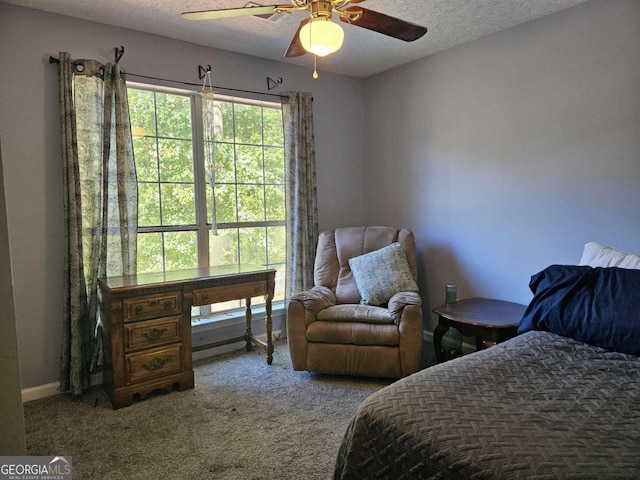 carpeted bedroom with a textured ceiling and ceiling fan