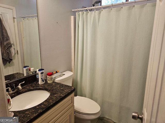 bathroom featuring toilet, a shower with curtain, and vanity