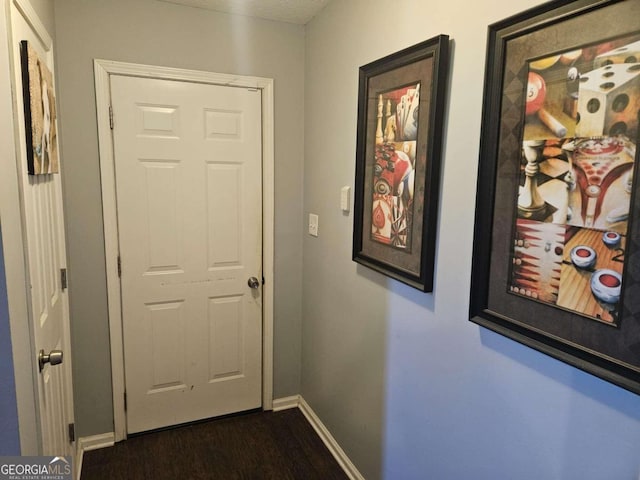 hallway with dark hardwood / wood-style flooring