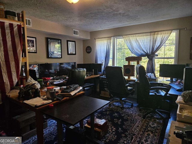 office space with a textured ceiling