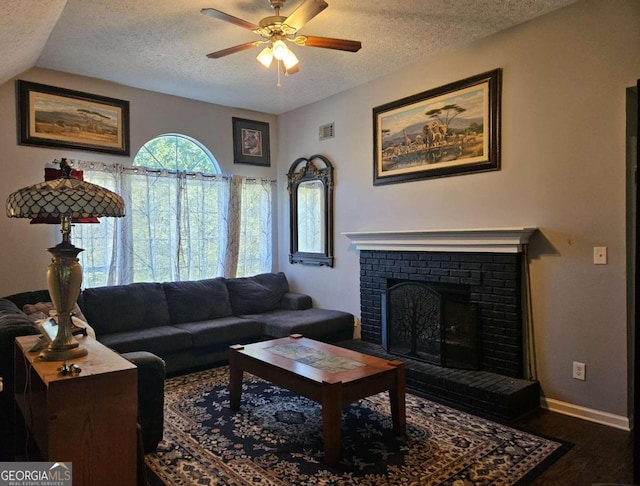 living room with a fireplace, wood-type flooring, a textured ceiling, and lofted ceiling