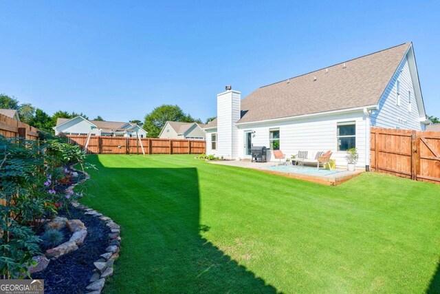 rear view of property featuring a yard and a patio area