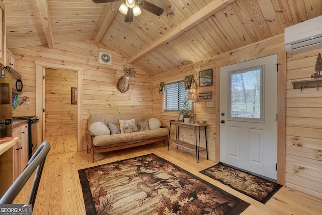 interior space with a wealth of natural light, wooden walls, vaulted ceiling with beams, and light hardwood / wood-style flooring