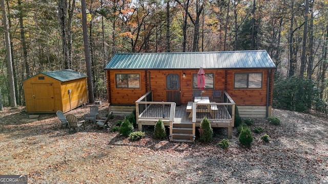 view of front of house featuring a shed and a wooden deck