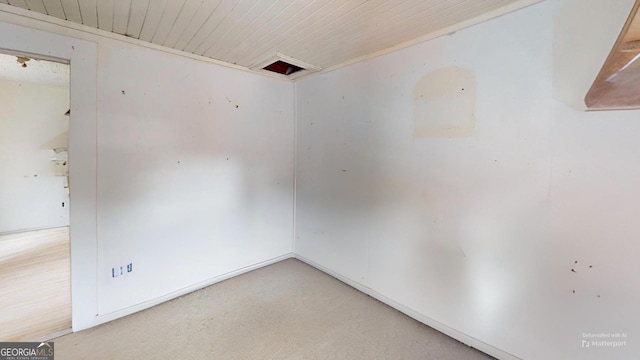 empty room featuring wooden ceiling