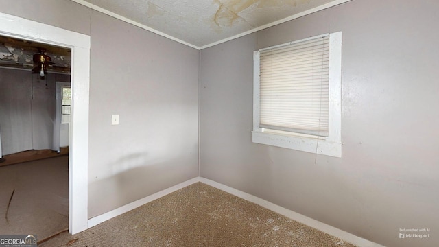 carpeted spare room featuring a textured ceiling and crown molding