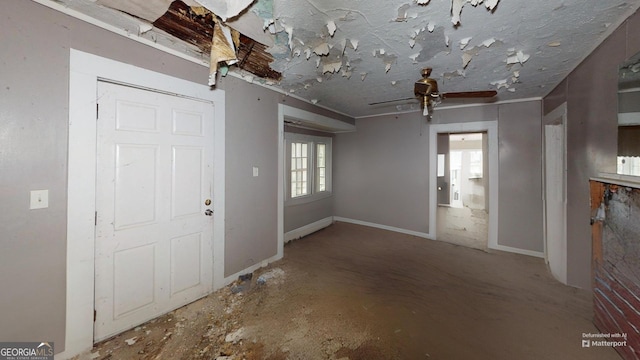 entrance foyer with ceiling fan and concrete floors