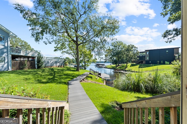 view of yard featuring a water view and a boat dock