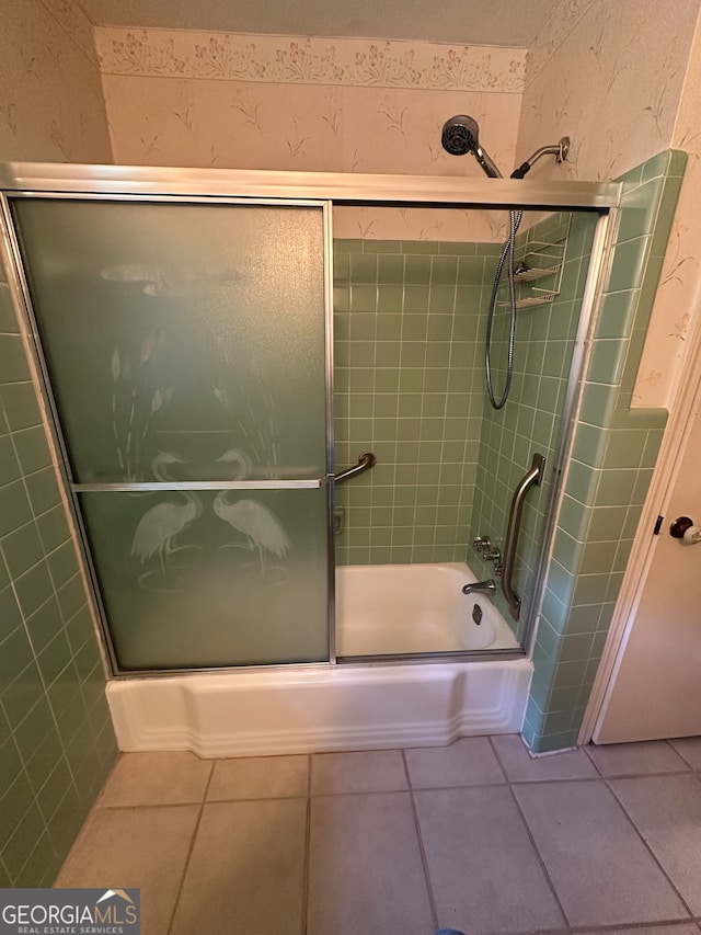 bathroom featuring combined bath / shower with glass door and tile patterned flooring