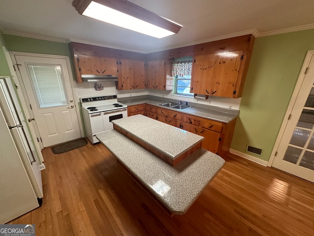 kitchen with ornamental molding, white appliances, sink, and dark hardwood / wood-style floors