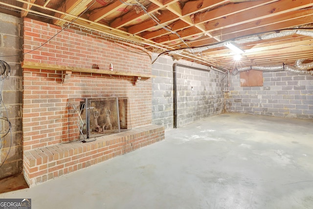 basement featuring a brick fireplace