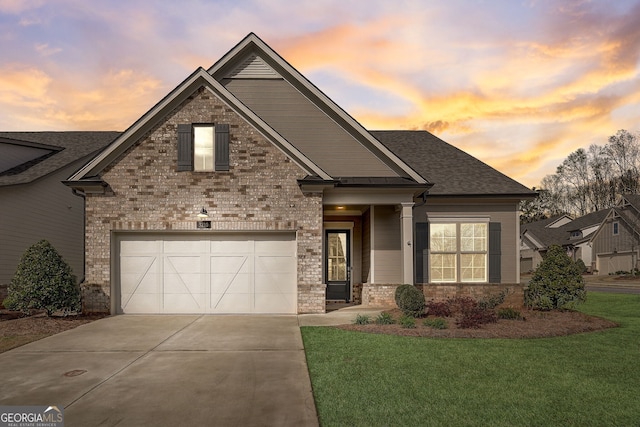 view of front of house featuring a garage and a yard