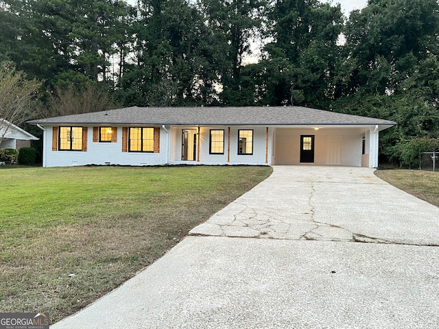 ranch-style home featuring a carport and a front yard