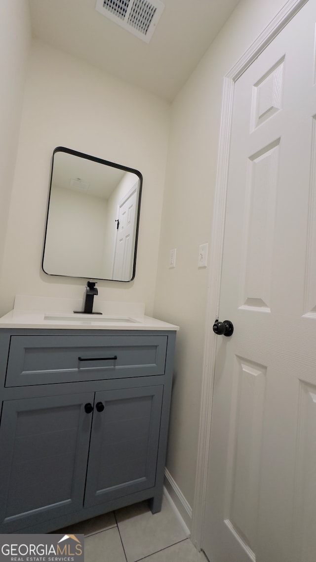 bathroom with tile patterned flooring and vanity