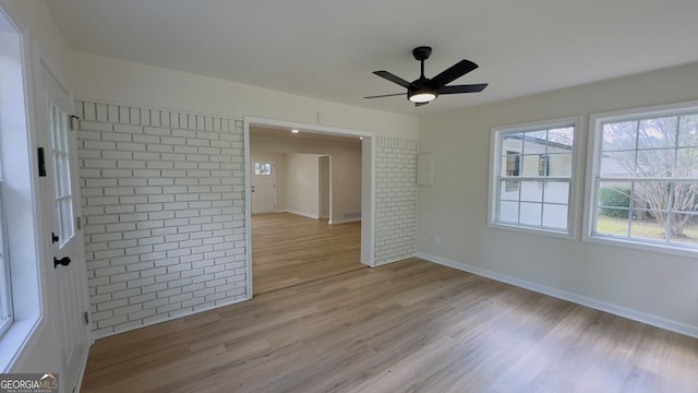 spare room with light hardwood / wood-style floors and ceiling fan