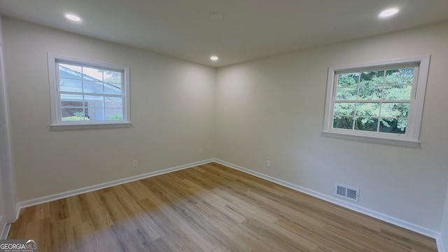 unfurnished room with a wealth of natural light and light wood-type flooring