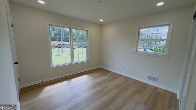 unfurnished room with light hardwood / wood-style floors and plenty of natural light