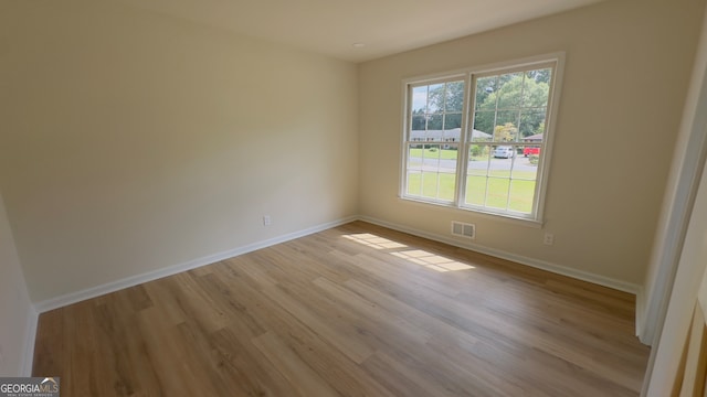 spare room featuring light hardwood / wood-style flooring