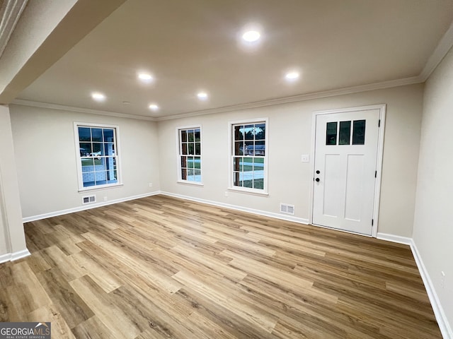 entryway featuring crown molding and light hardwood / wood-style flooring