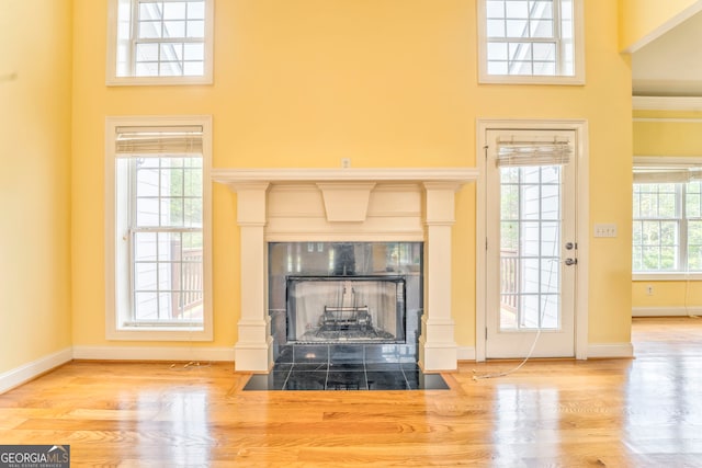 interior space featuring a tiled fireplace and hardwood / wood-style floors