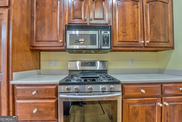 kitchen featuring appliances with stainless steel finishes and light stone countertops