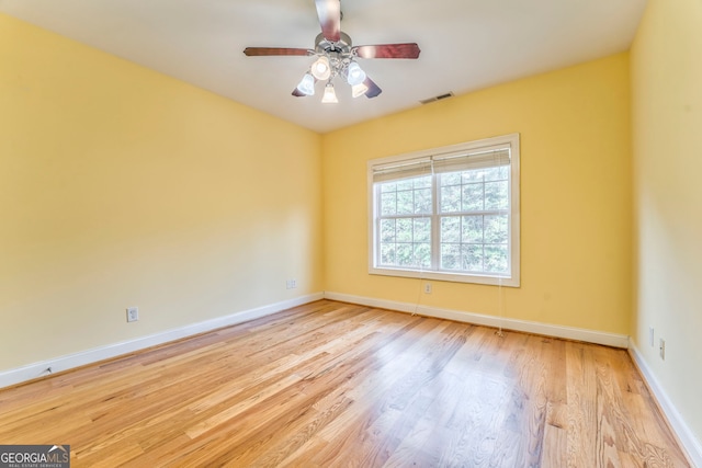 spare room featuring light wood-type flooring and ceiling fan