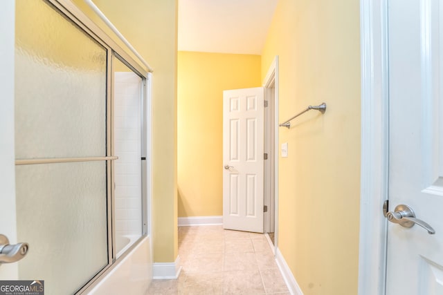 bathroom with shower / bath combination with glass door and tile patterned floors