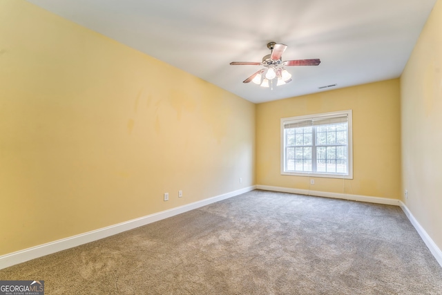 carpeted spare room featuring ceiling fan