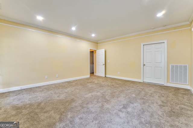 carpeted empty room featuring crown molding