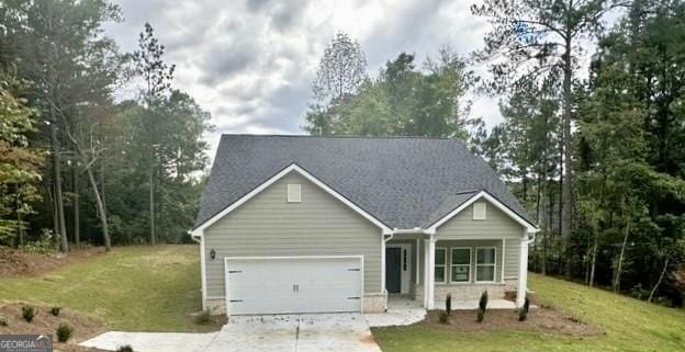 view of front of home with a garage and a front lawn