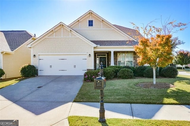 view of front of house with a garage and a front yard