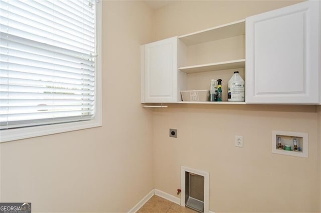 washroom featuring cabinets, electric dryer hookup, hookup for a washing machine, and light tile patterned flooring