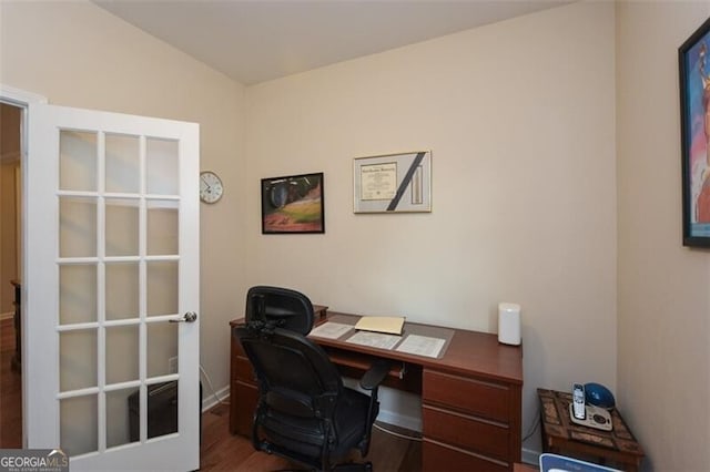 office area featuring dark wood-type flooring, french doors, and vaulted ceiling