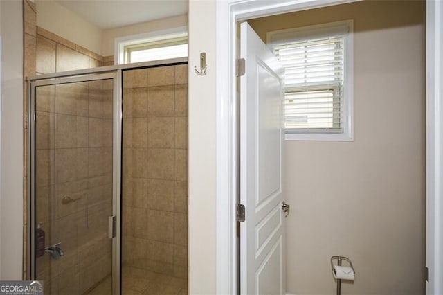 bathroom featuring a wealth of natural light and an enclosed shower