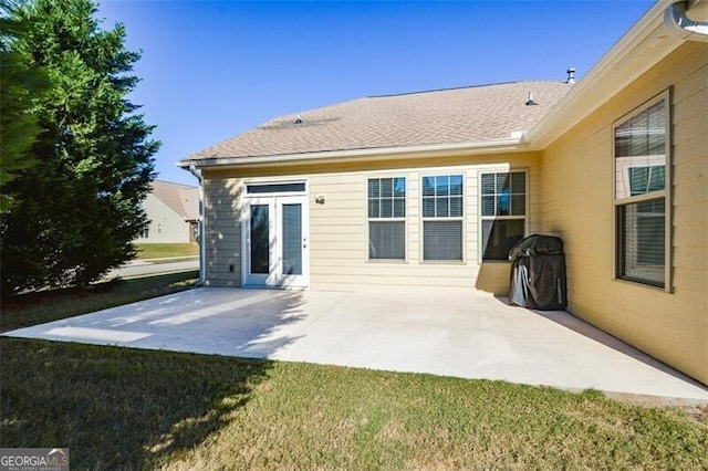 back of house with a patio and a yard