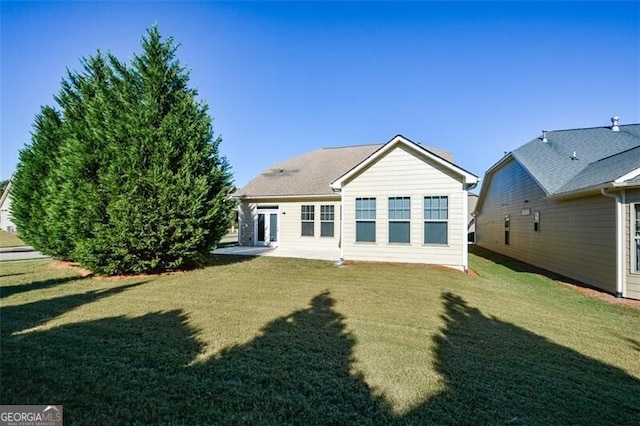 rear view of property featuring a yard