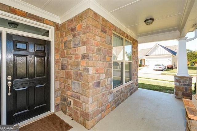 view of exterior entry featuring covered porch