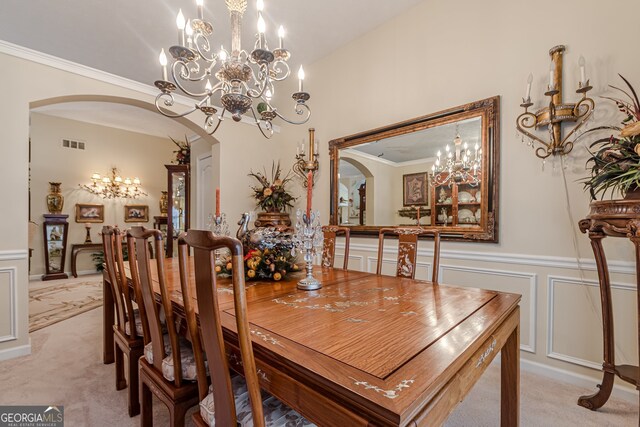 dining area with light colored carpet, a chandelier, and crown molding