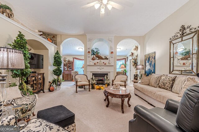 living room with ceiling fan and carpet