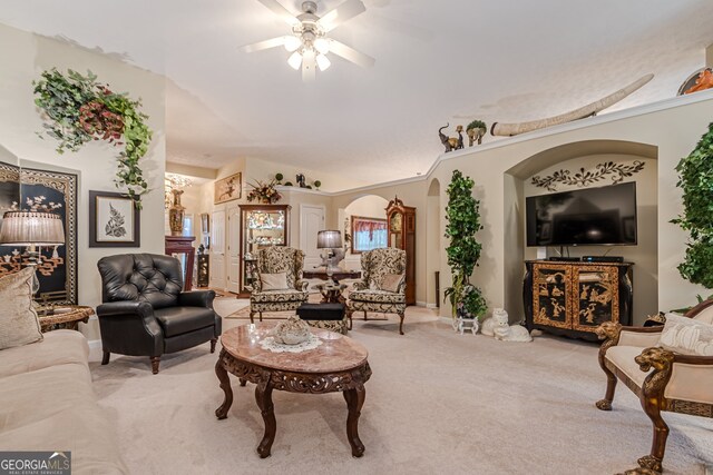 carpeted living room featuring ceiling fan