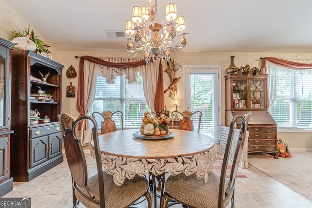 carpeted dining room with a chandelier