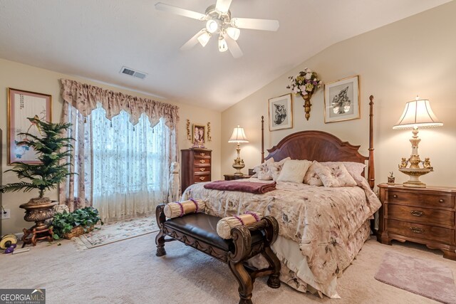 carpeted bedroom with ceiling fan and lofted ceiling