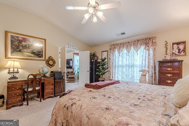 bedroom with vaulted ceiling, light colored carpet, and ceiling fan