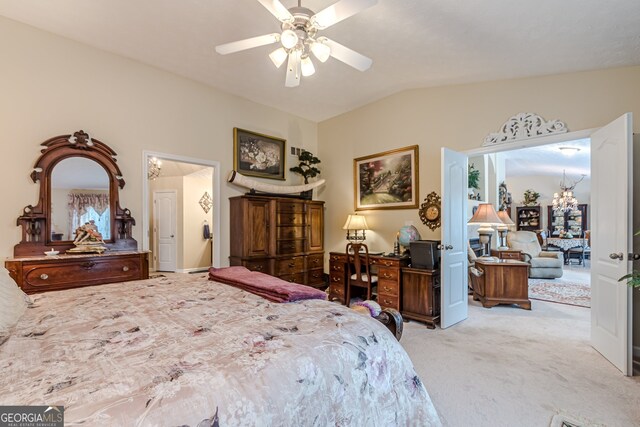 bedroom with ceiling fan with notable chandelier, vaulted ceiling, and light colored carpet