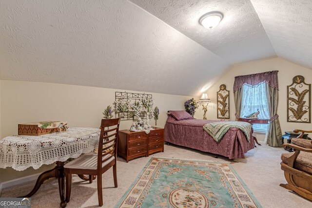 bedroom featuring a textured ceiling, light carpet, and vaulted ceiling