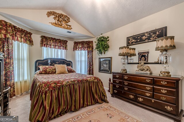 carpeted bedroom with a textured ceiling and vaulted ceiling