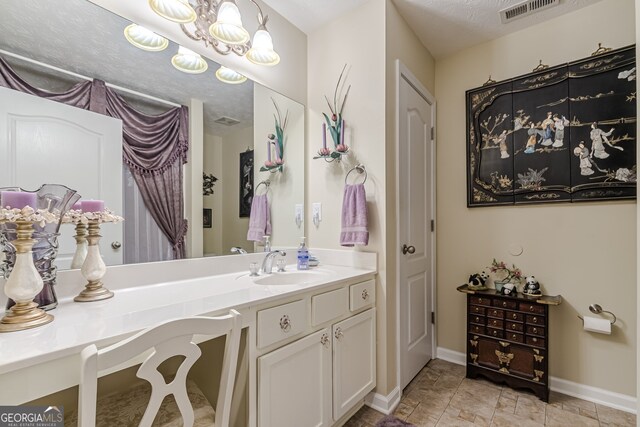 bathroom featuring vanity and a textured ceiling